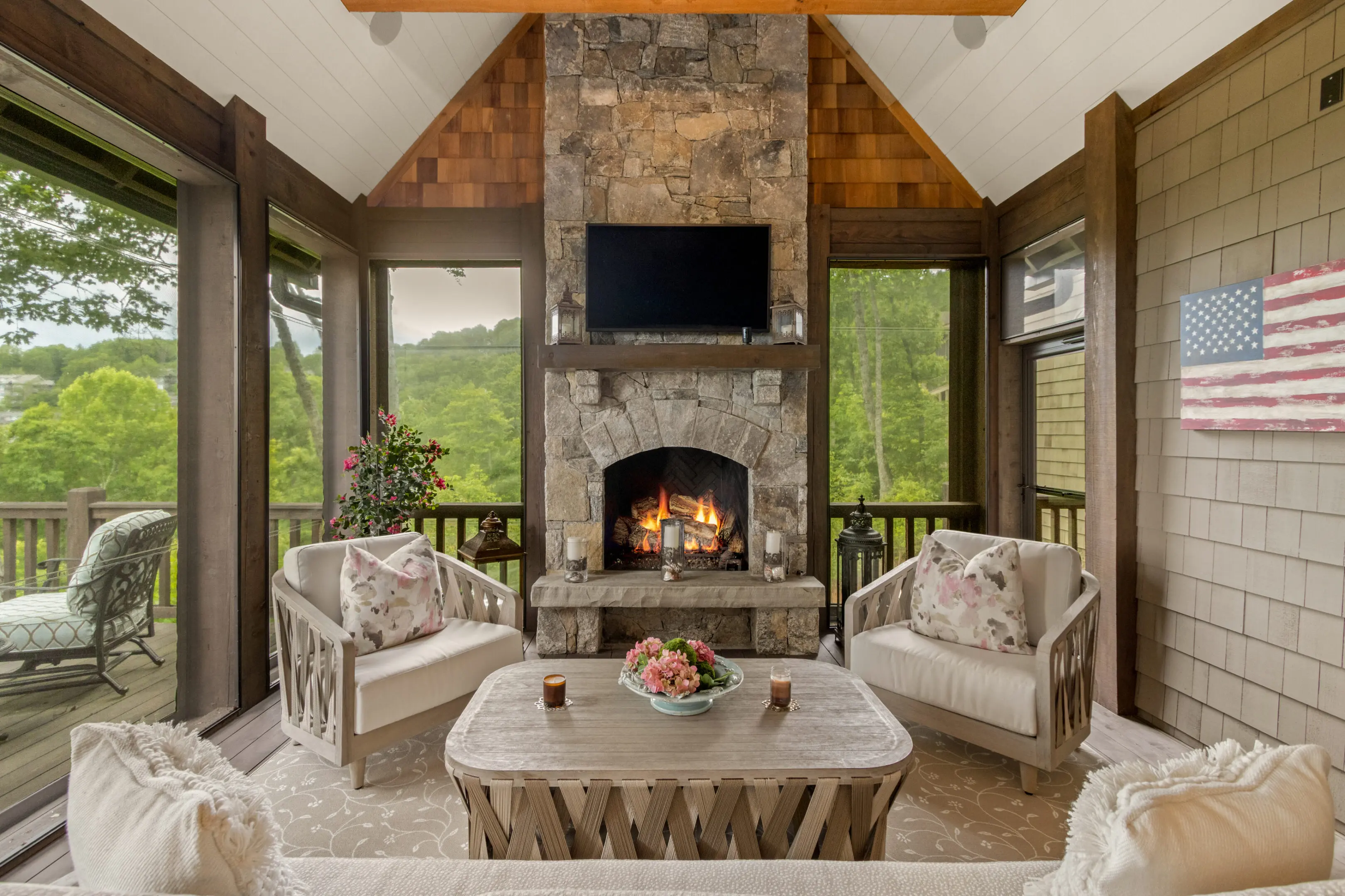 Cozy living room with stone fireplace and mountain views.
