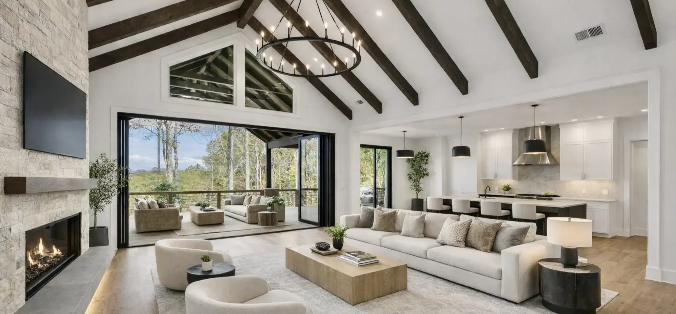 Bright modern living room with vaulted ceiling and large windows.